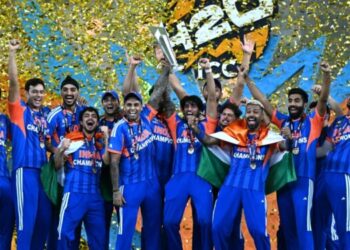 India's players celebrate with the trophy after winning the 2026 ICC Men's T20 Cricket World Cup final match against New Zealand at the Narendra Modi Stadium in Ahmedabad on March 8, 2026. (Photo by Punit PARANJPE / AFP)